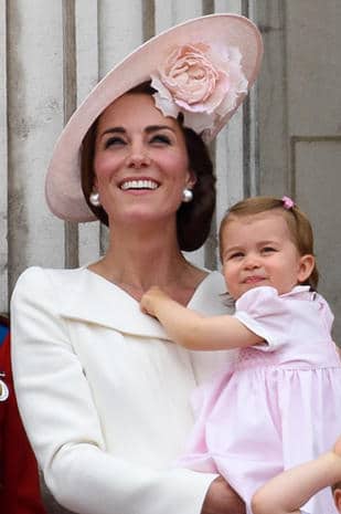LONDON, ENGLAND - JUNE 11:Catherine, Duchess of Cambridge and Princess Charlotte of Cambridge watch a fly past during the Trooping the Colour, this year marking the Queen's 90th birthday at The Mall on June 11, 2016 in London, England. The ceremony is Queen Elizabeth II's annual birthday parade and dates back to the time of Charles II in the 17th Century when the Colours of a regiment were used as a rallying point in battle. (Photo by Ben A. Pruchnie/Getty Images)