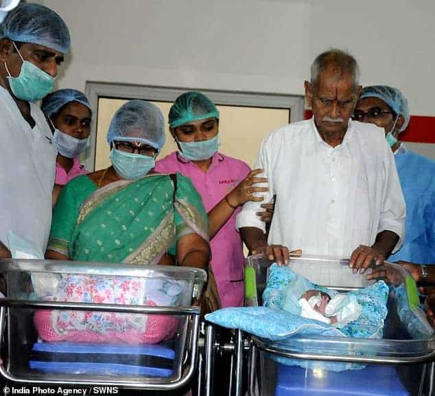 Bebês gêmeas com o pai e equipe médica após nascerem