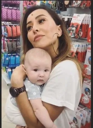 Sabrina Sato segurando um bebê no colo durante a compra do enxoval de sua bebê