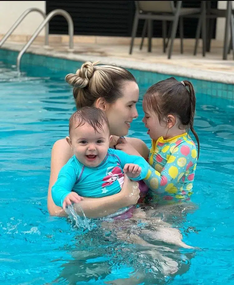 Thaeme posa com as duas filhas na piscina