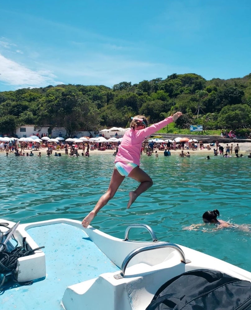 Nina, filha de Mel e Rodrigo Santoro, pulando do barco